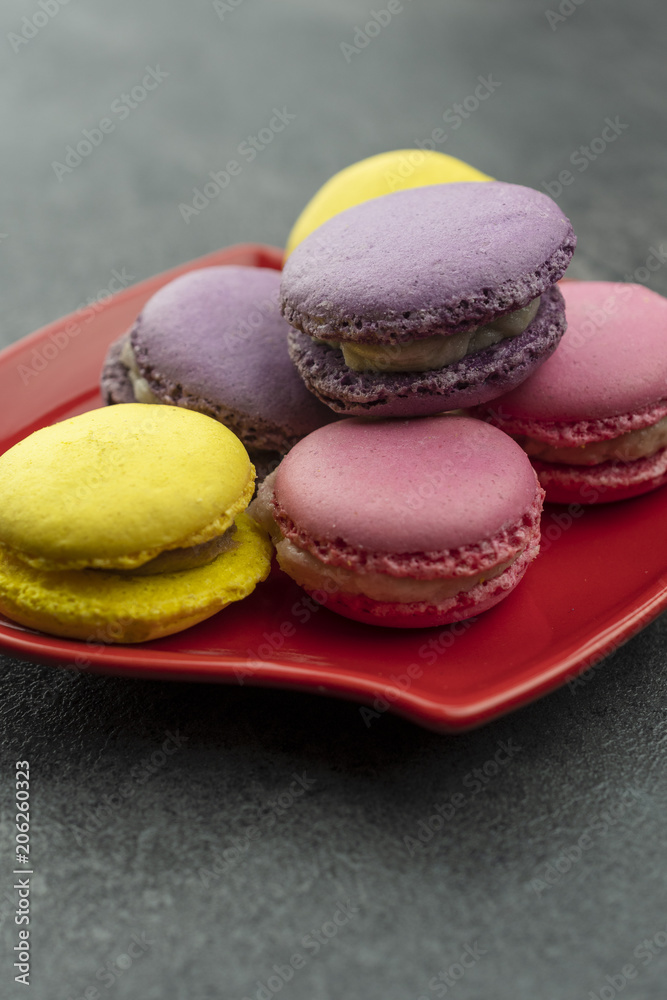 Macaroons on the red plate.