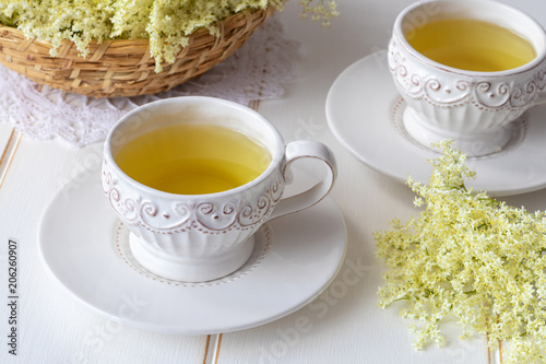 Two cups of herbal tea with fresh elder flowers