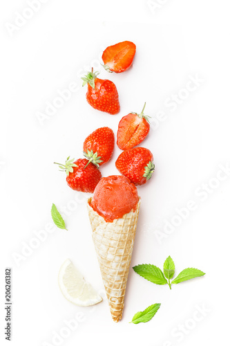Fototapeta Naklejka Na Ścianę i Meble -  Strawberry ice cream in a waffle horn, mint and lime and berries of fresh strawberries on a white background