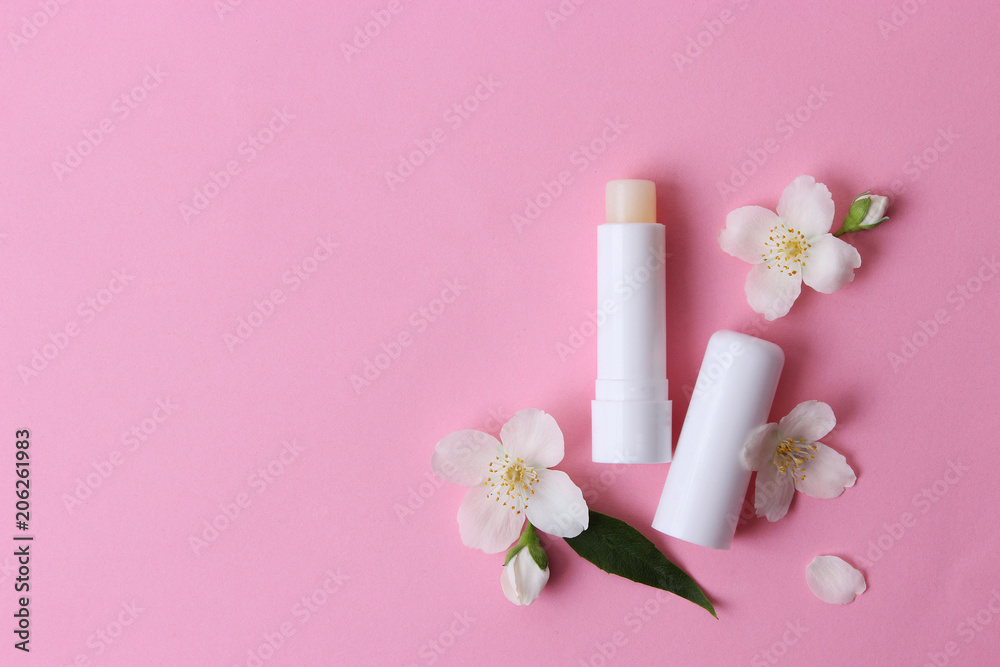 lip balm and flowers on a colored background. minimalism, the top lip balm and flowers on a colored background. minimalism, the top