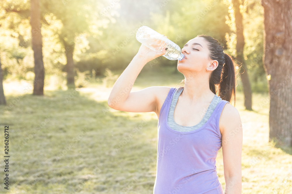 Young woman drinking water after workout, feeling good. Active lifestyle. Young woman drinking water after workout, feeling good. Active lifestyle.