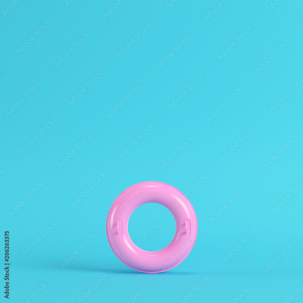 Yellow inflatable ring on bright blue background in pastel colors Yellow inflatable ring on bright blue background in pastel colors