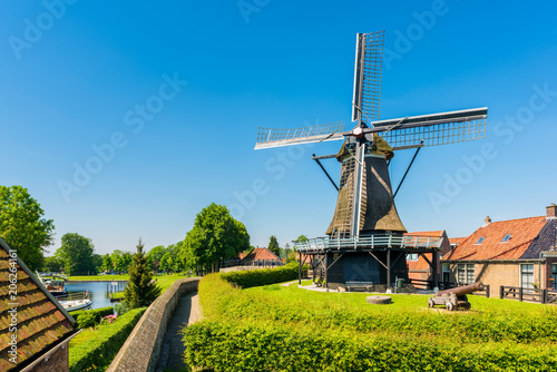 Windmill in the village of Sloten, Friesland, Netherlands on spring day