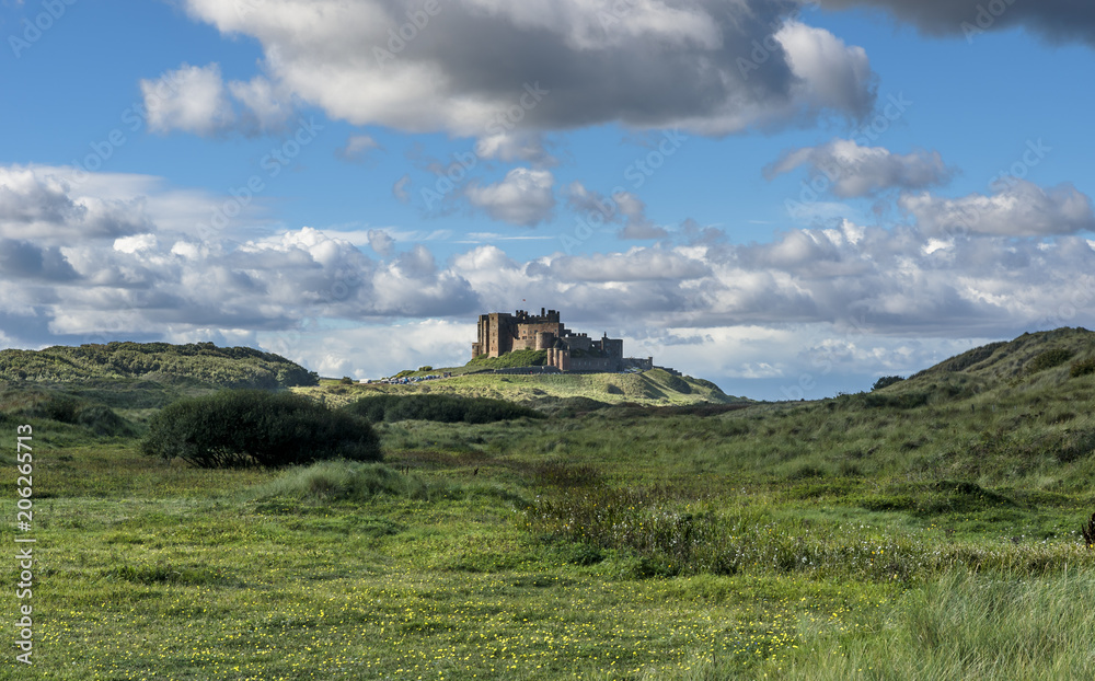 Bamburgh Castle view with blue sky and clouds Bamburgh Castle view with blue sky and clouds
