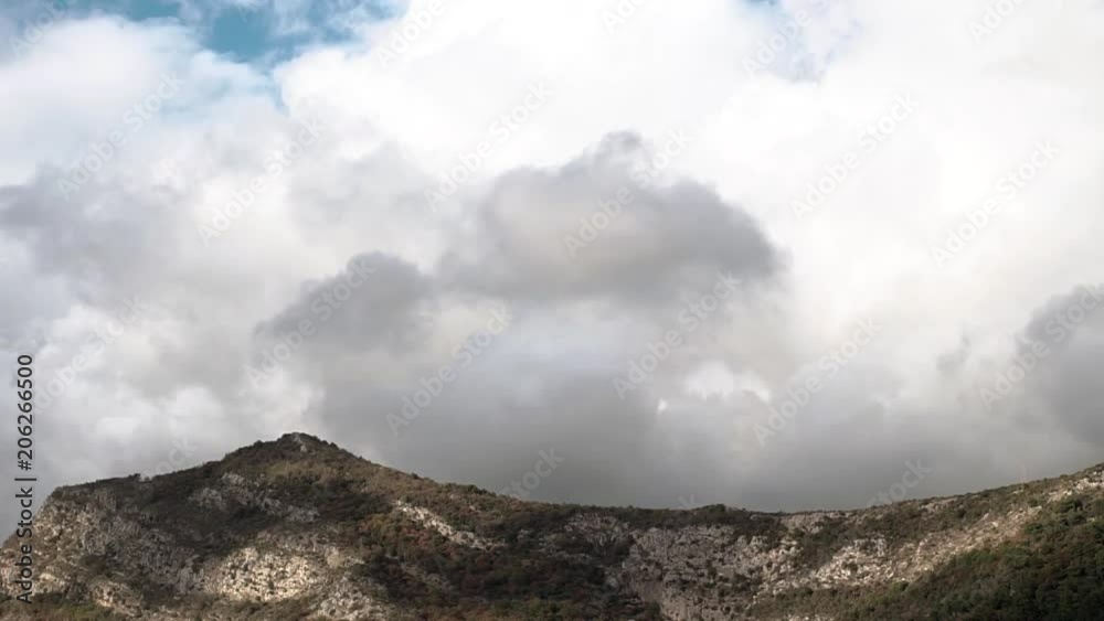 Beautiful White Fluffy Cumulus Clouds Curling Over Green Hill. Concept Nature Beautiful White Fluffy Cumulus Clouds Curling Over Green Hill. Concept Nature
