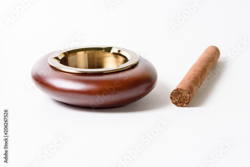 Stylish exquisite ashtray and cigar on white background