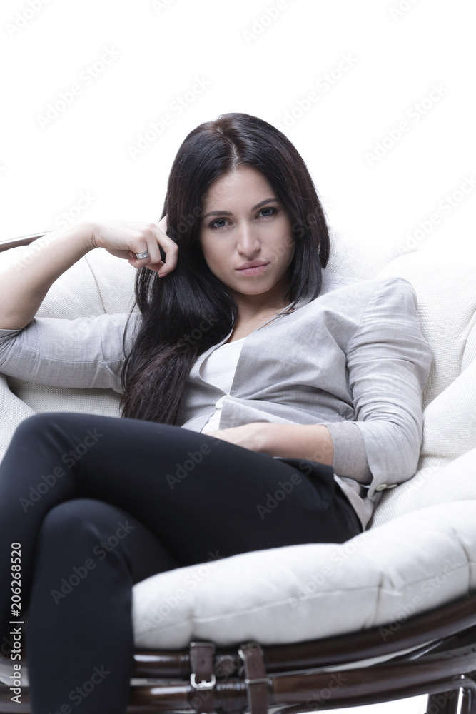 young woman sitting in a comfortable soft big armchair young woman sitting in a comfortable soft big armchair