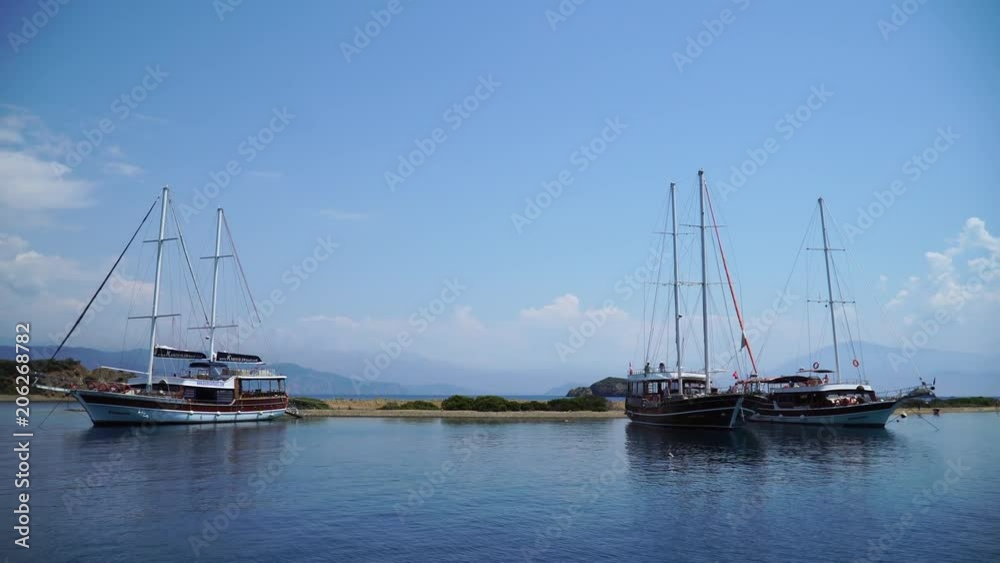 Tourists sailing boats on Yassica Islands in Mediterranean sea. Turkey. 4K. Tourists sailing boats on Yassica Islands in Mediterranean sea. Turkey. 4K.