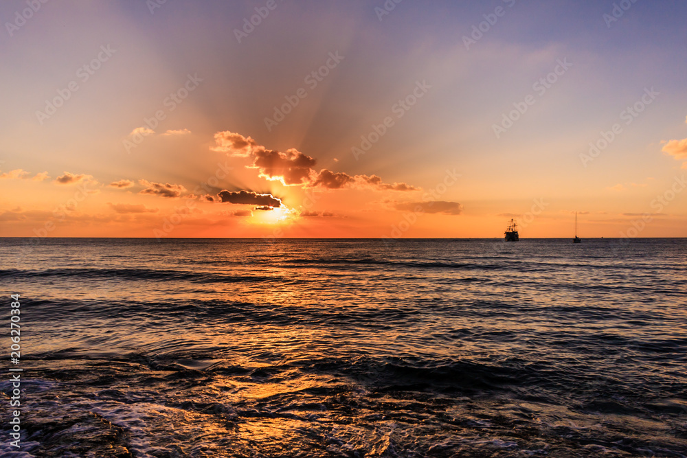 Sunset over the Caribbean sea. The photo was taken in Cozumel Mexico. Beautiful seascape.