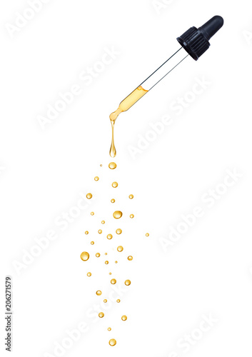 Close-up of dropper with falling drops isolated on white background photo