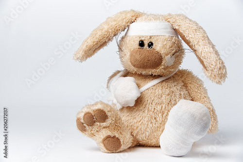 Cute sick bandaged hare on a white background.