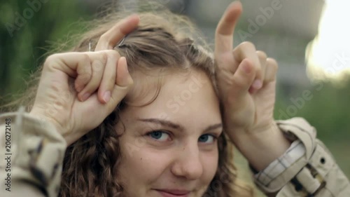 Portrait of a funny girl who is acting like a little creature.