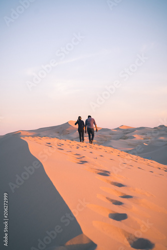 couple on dune in desert