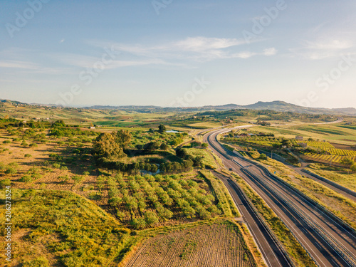 Photography Beautiful aerial view of the highway in Italy with cars passing by