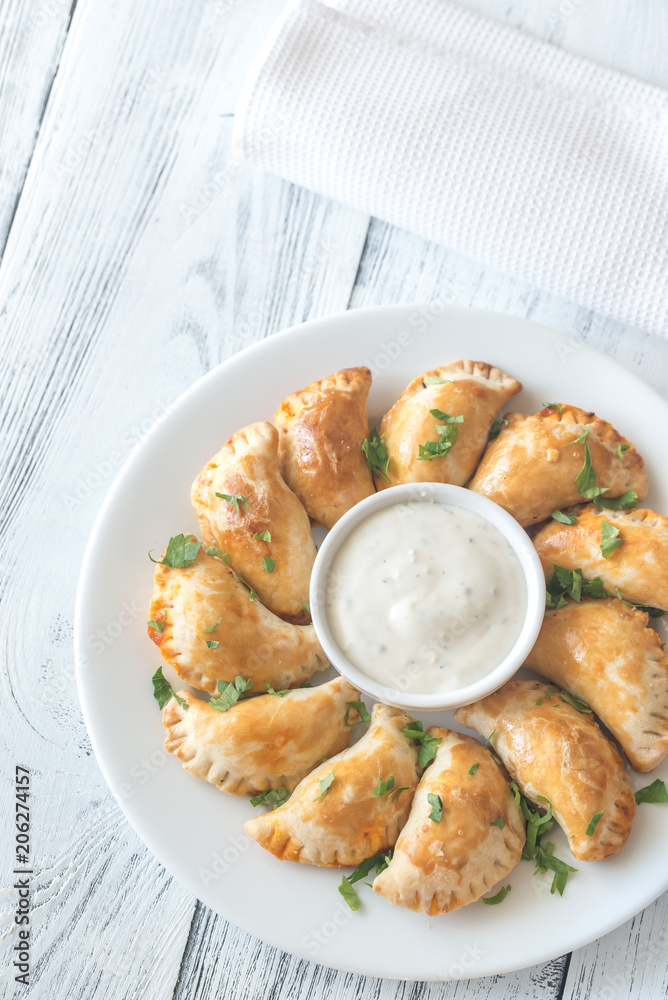 Mini chicken pies with creamy garlic sauce