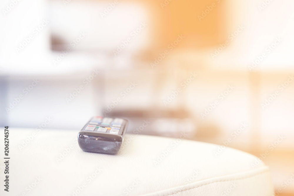 TV remote control on couch indoors, closeup. Home cinema. Toning TV remote control on couch indoors, closeup. Home cinema. Toning