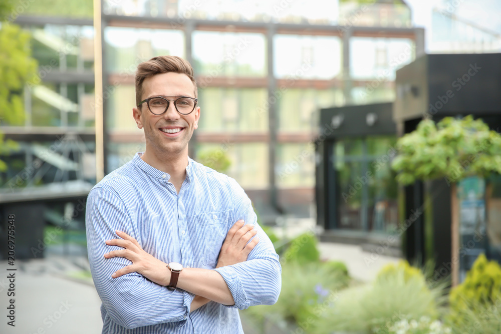 Portrait of attractive young man in stylish outfit outdoors