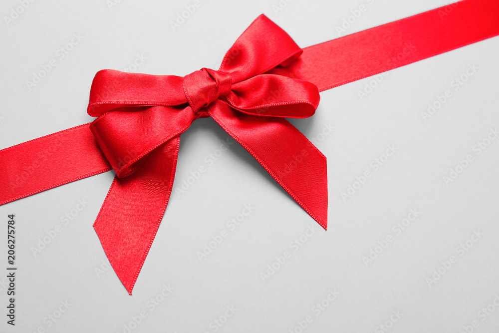 Beautiful red ribbon with bow on light background Beautiful red ribbon with bow on light background