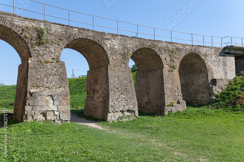 Arched Bridge over the moat in Koporye Fortress, Leningrad Region, Russia. Stone fort built by 1297