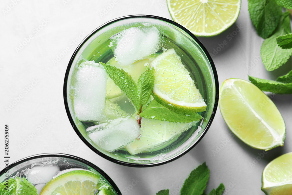 Refreshing beverage with mint and lime in glass on table, top view Refreshing beverage with mint and lime in glass on table, top view