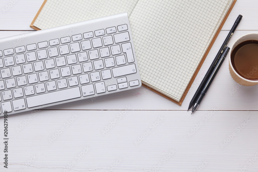top view image of open notebook with blank pages next to cup of coffee on wooden table. ready for adding text or mockup. top view image of open notebook with blank pages next to cup of coffee on wooden table. ready for adding text or mockup.