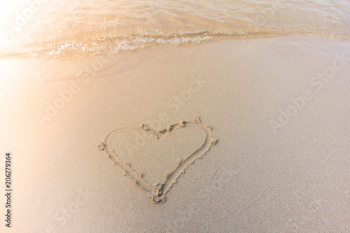 Beautiful background beach with heart in summer. Royalty high-quality free stock image of shape heart draw on the sand and beach