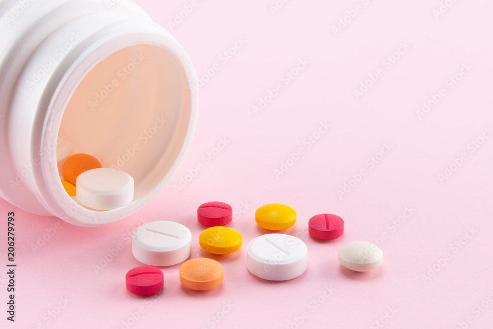 colorful pills spilling out of the medicine bottle colorful pills spilling out of the medicine bottle