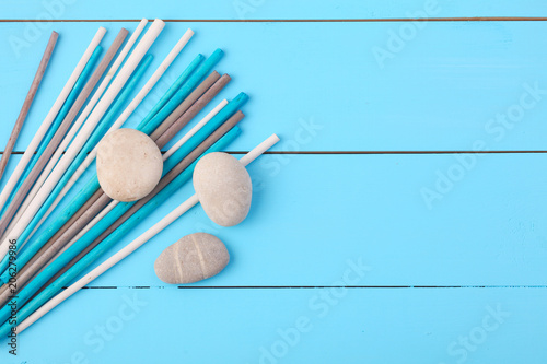 Stones and plant on the wooden background.