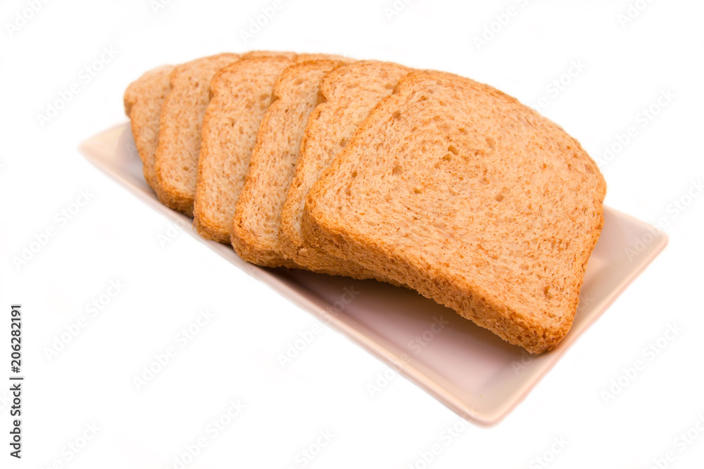 Slices of wholemeal bread on a white background close up view Slices of wholemeal bread on a white background close up view