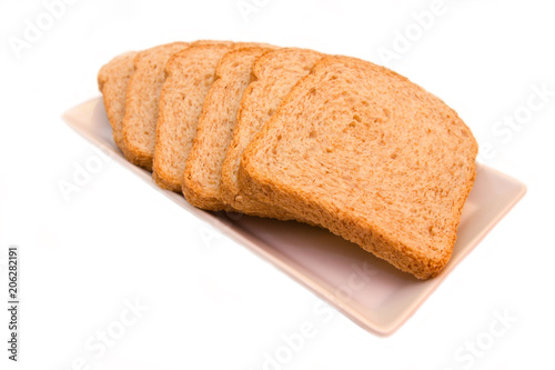 Slices of wholemeal bread on a white background close up view