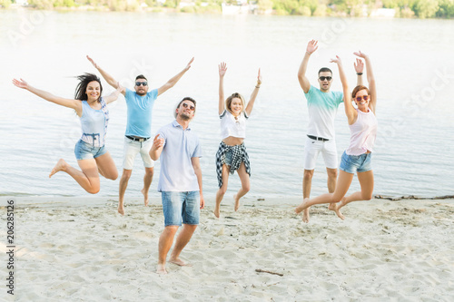 Group of people jumping on the beach