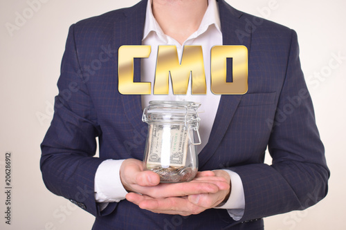 A businessman with a bank of money shows an inscription:CMO