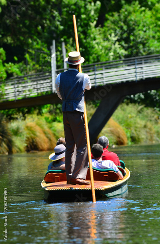Unrecognizable people punting on the Avon river Christchurch - New Zealand