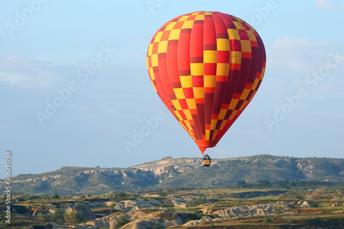 balloon is flying in mountainous area in Cappadocia. Turkey