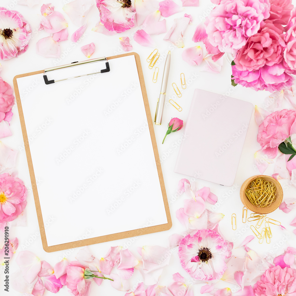 Beauty blog composition with dairy, pink roses, petals, pen and clipboard on white background. Top view. Flat lay.
