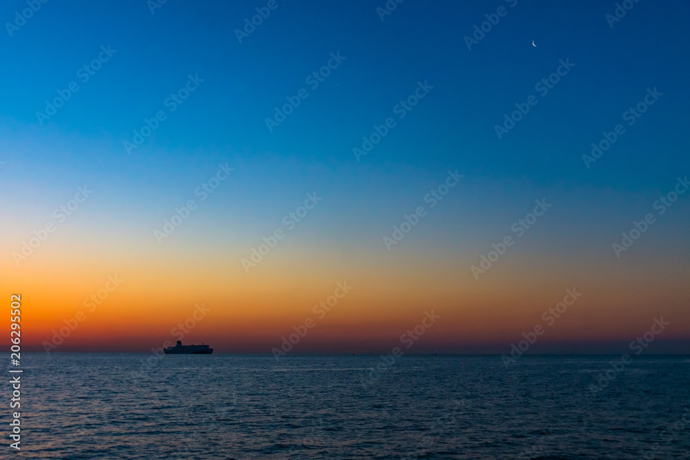 朝焼けの海と空と月と船
