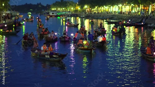 Hoian, Vietnam - MAY 2018: Night river view with floating lanterns and boats. Hoi An, once known as Faifo. Hoian is a city in Vietnam and noted since 1999 as a UNESCO World Heritage Site photo