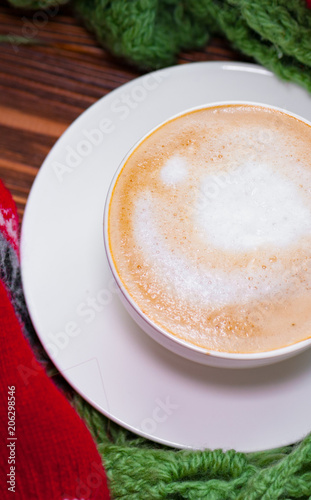 Vertical view of cup of coffee with marshmallow on the wooden background. Instagram filter