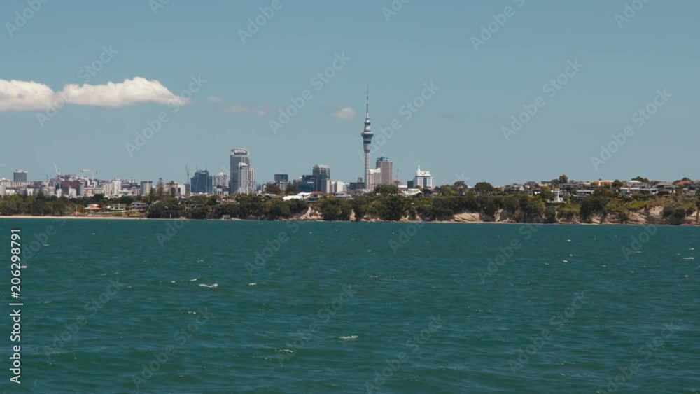 Slow motion Auckland city and Sky Tower from passing boat Slow motion Auckland city and Sky Tower from passing boat