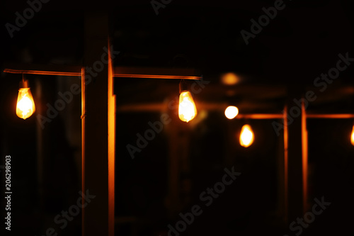 lamp light on wood pole in the dark night