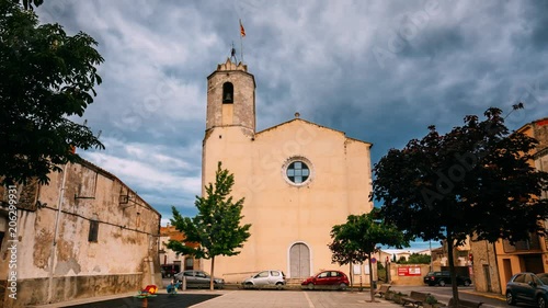 L'Armentera, Girona, Spain. Time Lapse, Timelapse, Time-lapse Of The Church Of Our Lady Of Armentera In Sunny Summer Evening photo