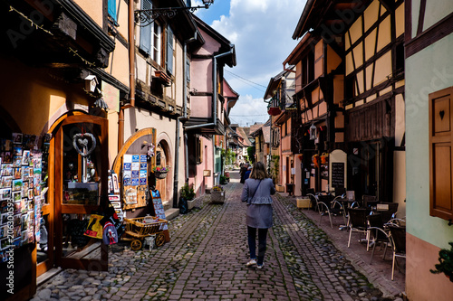 Canvas Print people walking along cobbled street between beautiful half-timbered houses in Eg