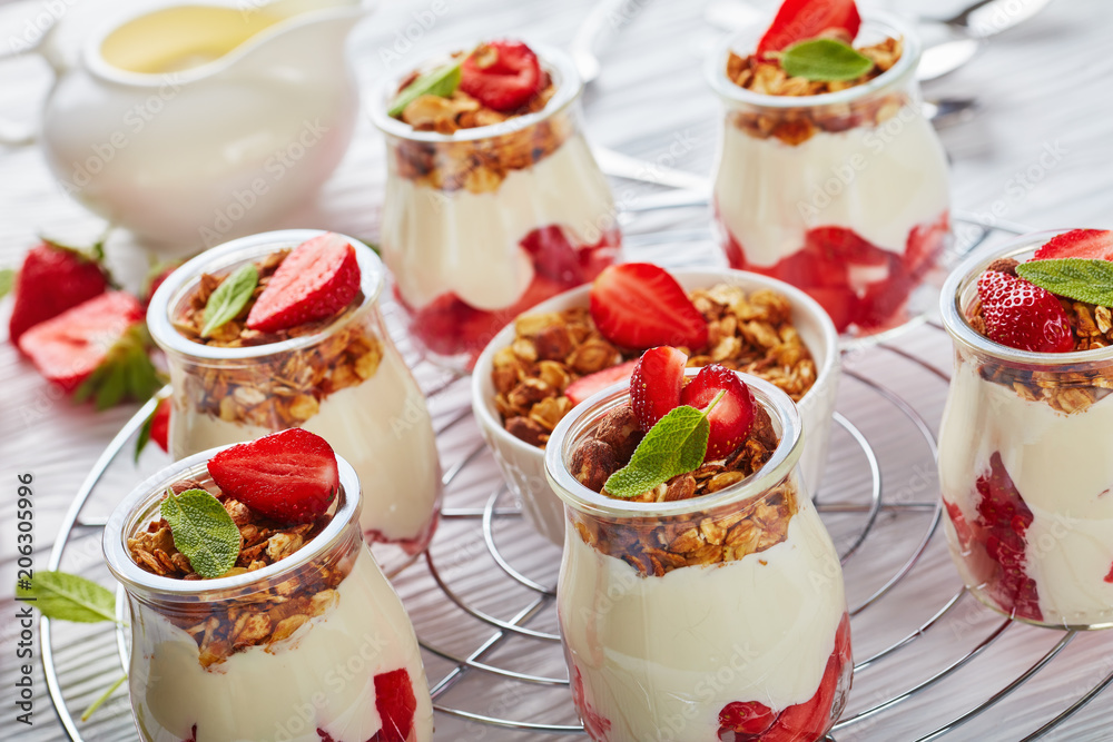 granola, yogurt, ripe strawberries in jars granola, yogurt, ripe strawberries in jars