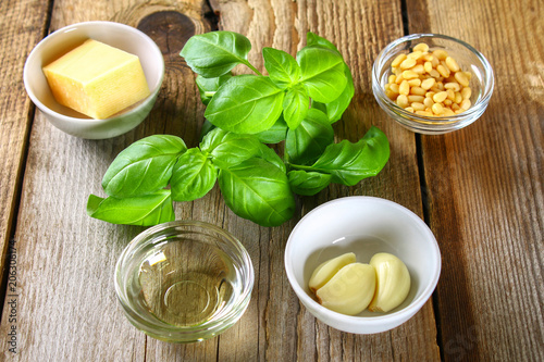 Ingredients for pesto sauce. Cheese, garlic, basil, pine nuts, olive oil.