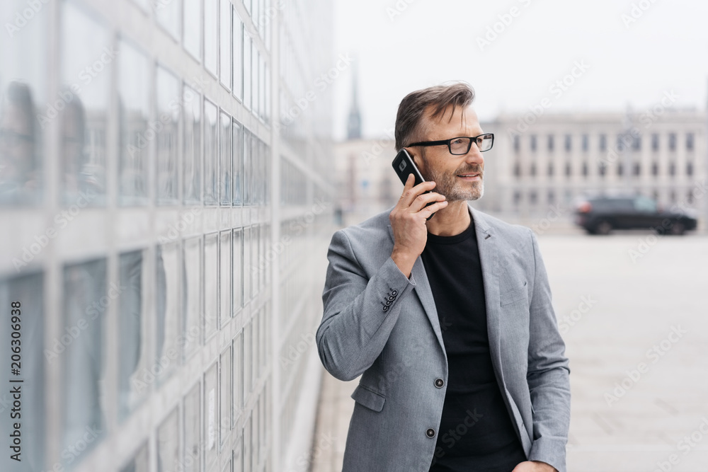 Businessman talking on a mobile in town Businessman talking on a mobile in town