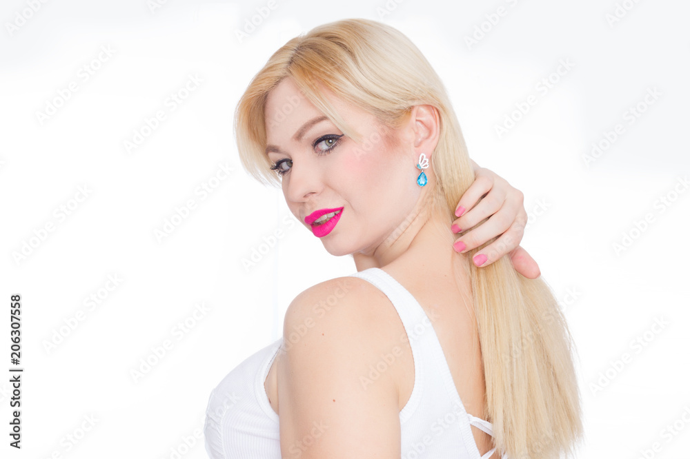 Close Up beauty portrait blonde with long hair, she with bright makeup, pink lips. Green eyes. Blue earrings. White background Close Up beauty portrait blonde with long hair, she with bright makeup, pink lips. Green eyes. Blue earrings. White background
