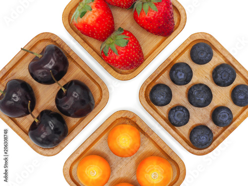 Fresh summer fruits  Cherry  strawberry  cape gooseberry and blueberry in wooden plate isolated on white background.