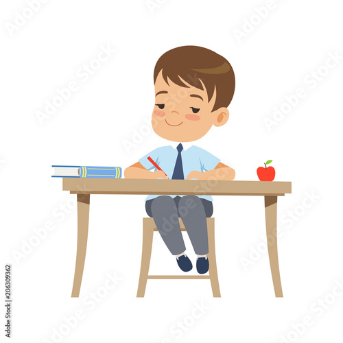 Cute boy sitting at the desk and writing, elementary school student in uniform vector Illustration on a white background