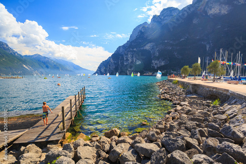 Fototapet Italy holiday destination, swimming in water in lake