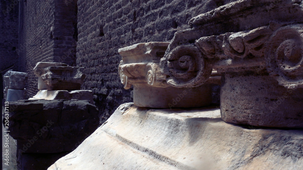 tracking shot on the remains of capitals of ionic column capitals